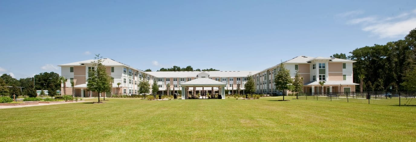Exterior view of Kenwood Place Apartments with landscaped grounds