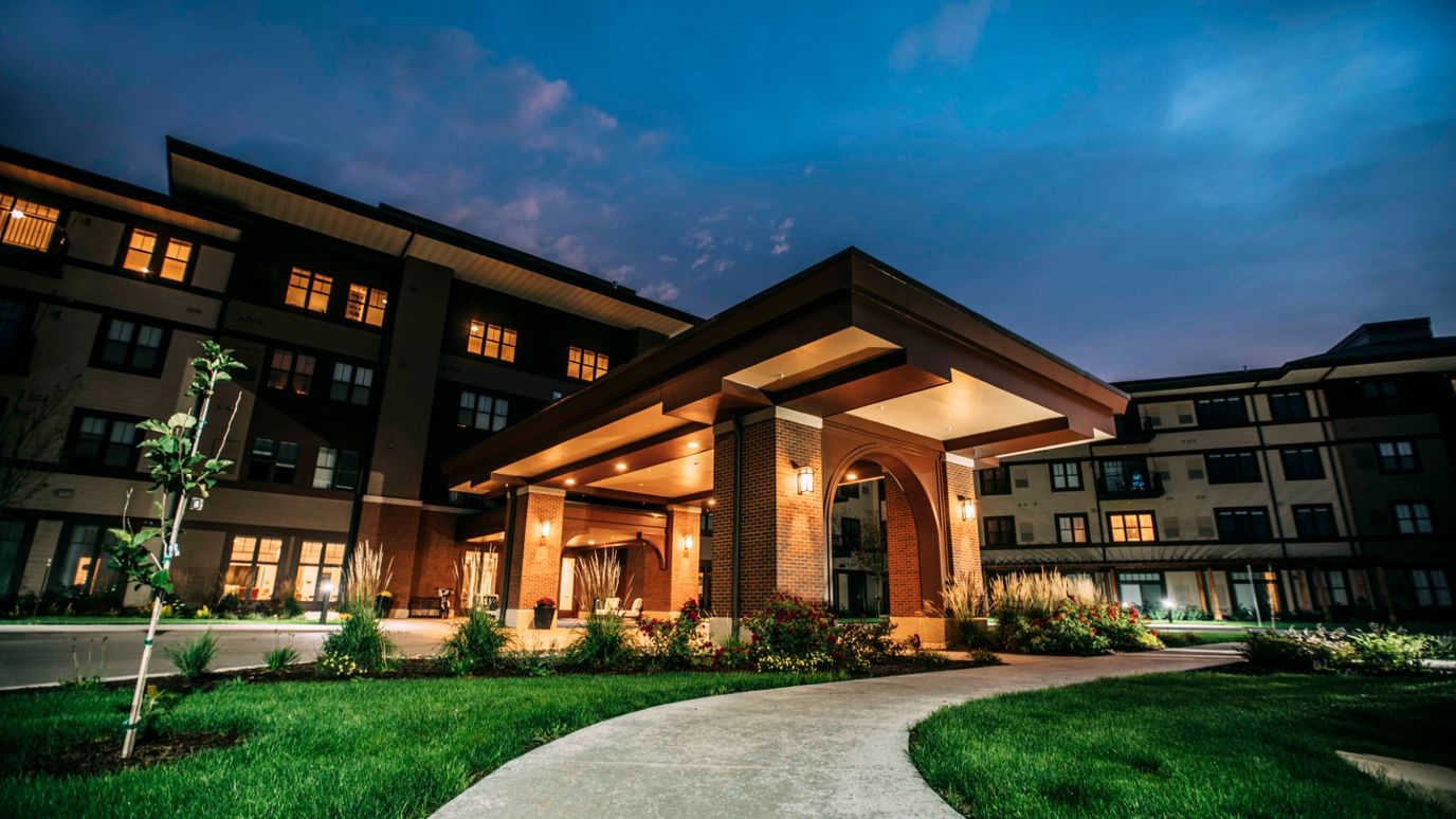 Entrance of The Summit of Coralville at dusk