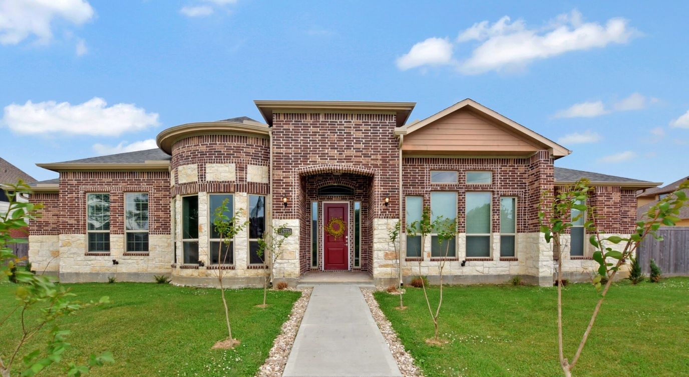 Exterior view of the assisted living facility with landscaped yard
