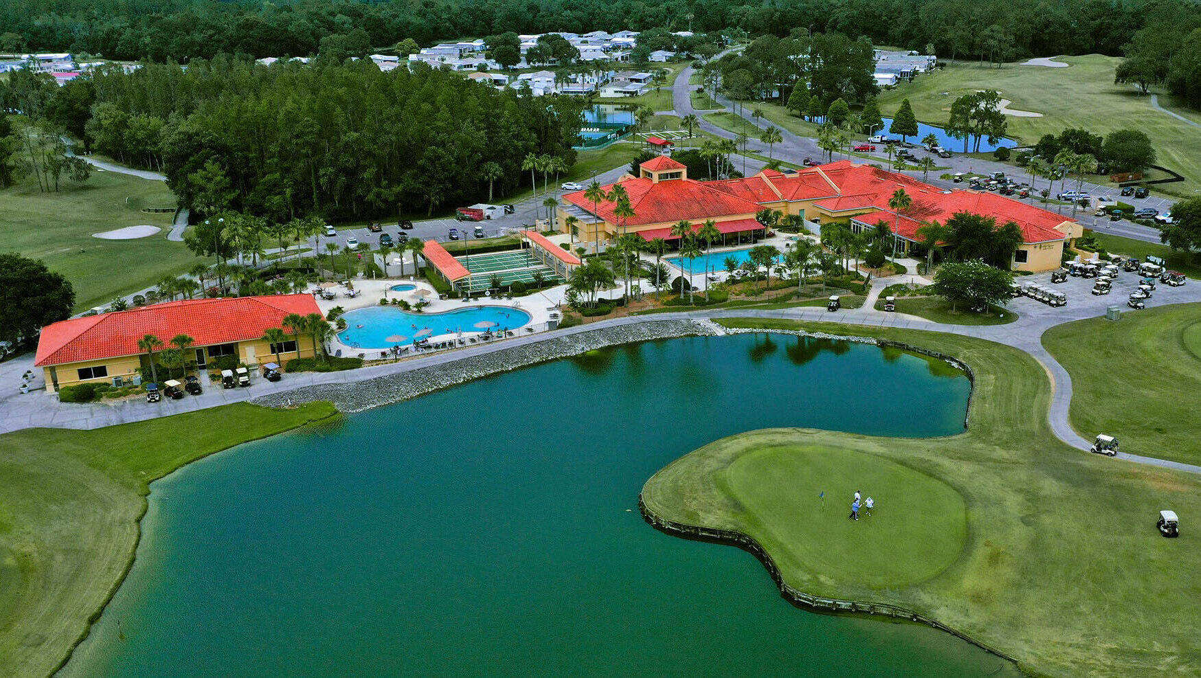 Aerial view of Cypress Lakes Village with golf course and pools