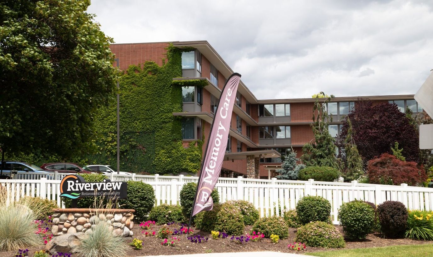 Exterior view of Riverview Retirement Community with flower beds