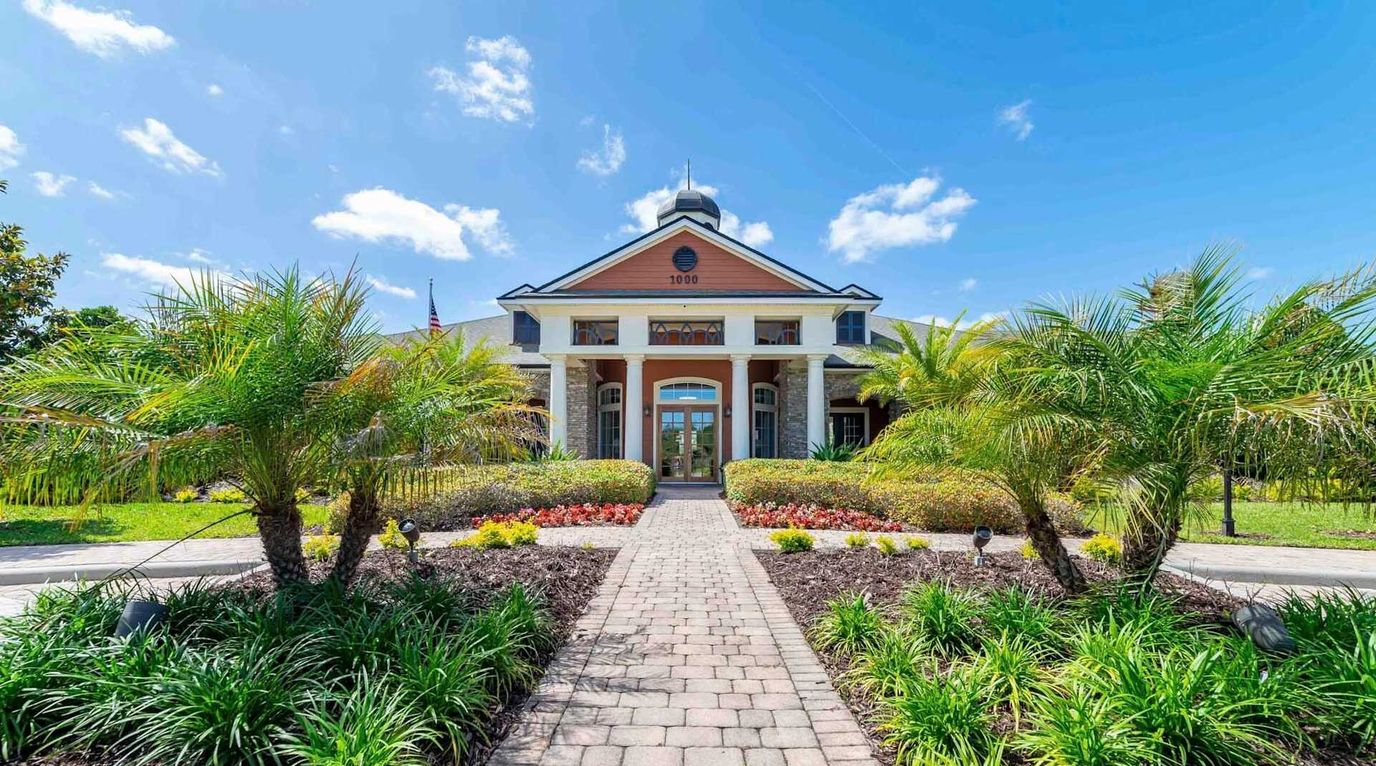 Beautiful view of the exterior entrance with landscaping