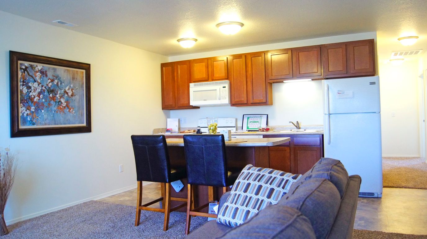 Modern kitchen setup with wooden cabinets and a dining area