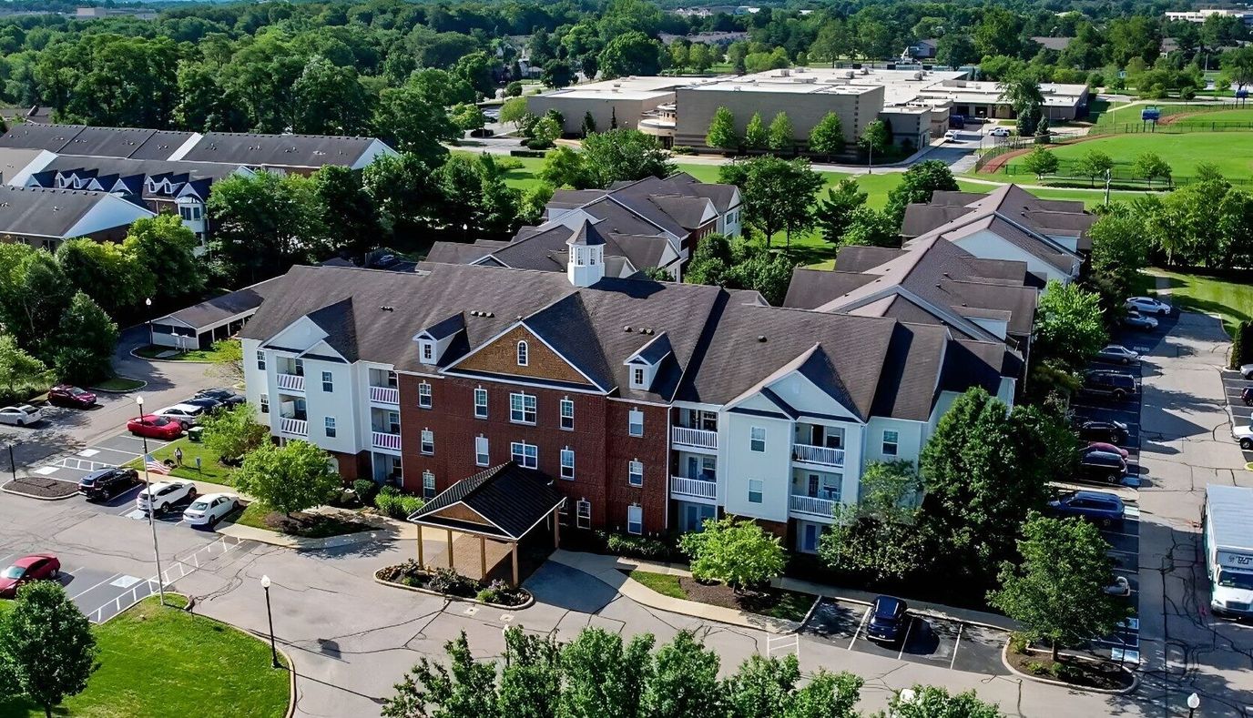 Aerial view of The Gallery Apartments complex with surrounding greenery