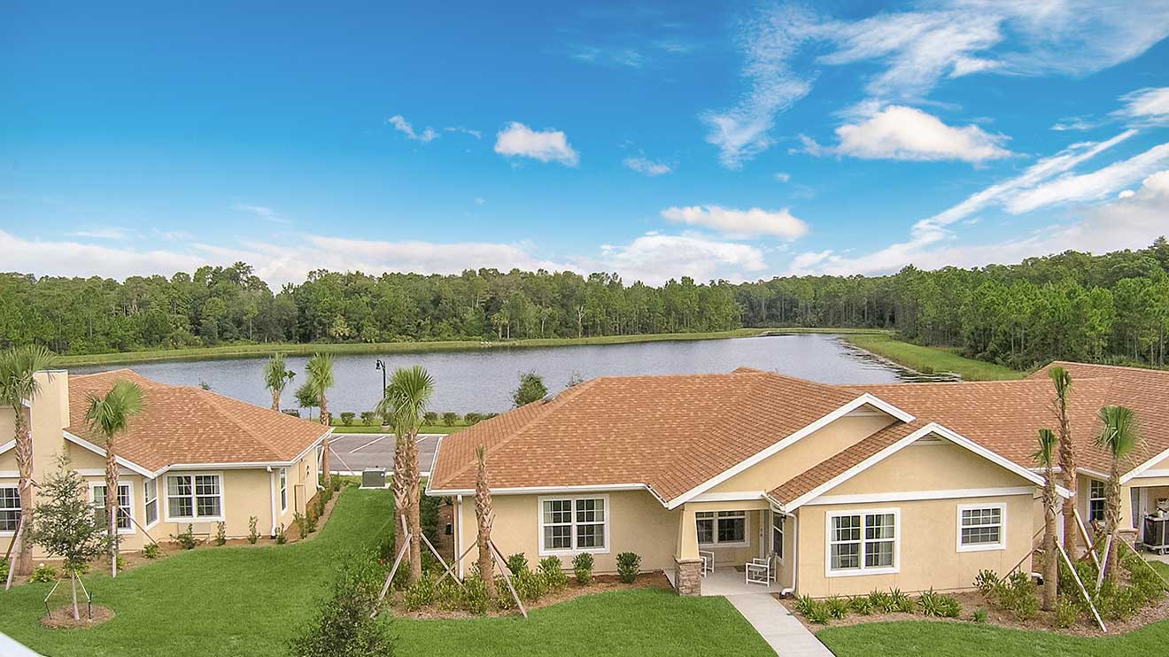 Aerial view of a senior living facility by a lake