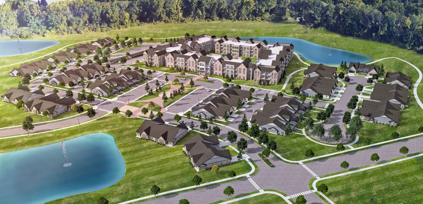 Aerial view of a senior living community with multiple buildings and water features