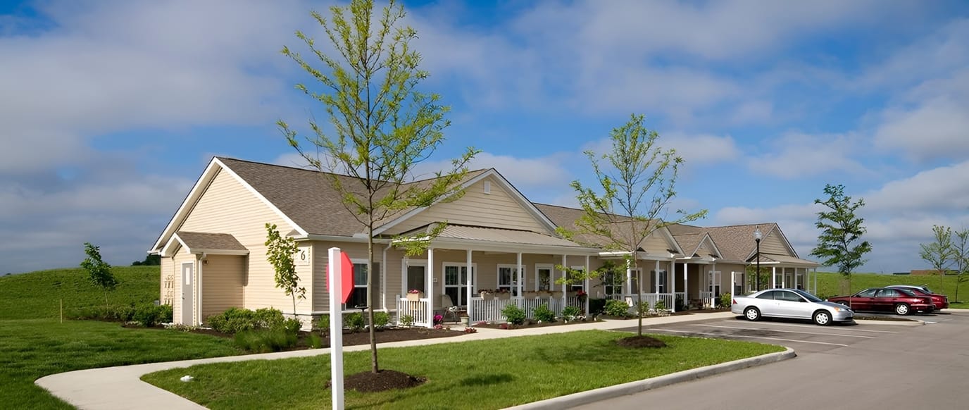 Exterior view of Meredith Meadows facility with greenery