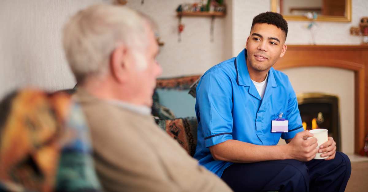 Staff member interacting with a resident in a cozy living space