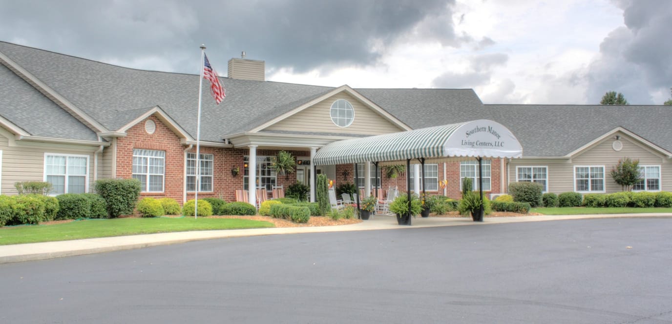 Exterior view of a senior living facility with a canopy