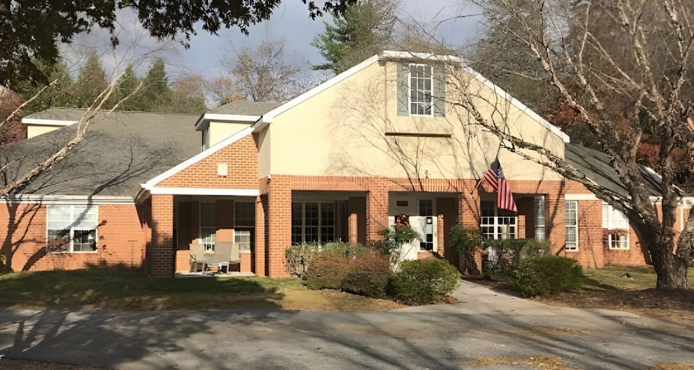 Exterior view of a senior living facility with American flag