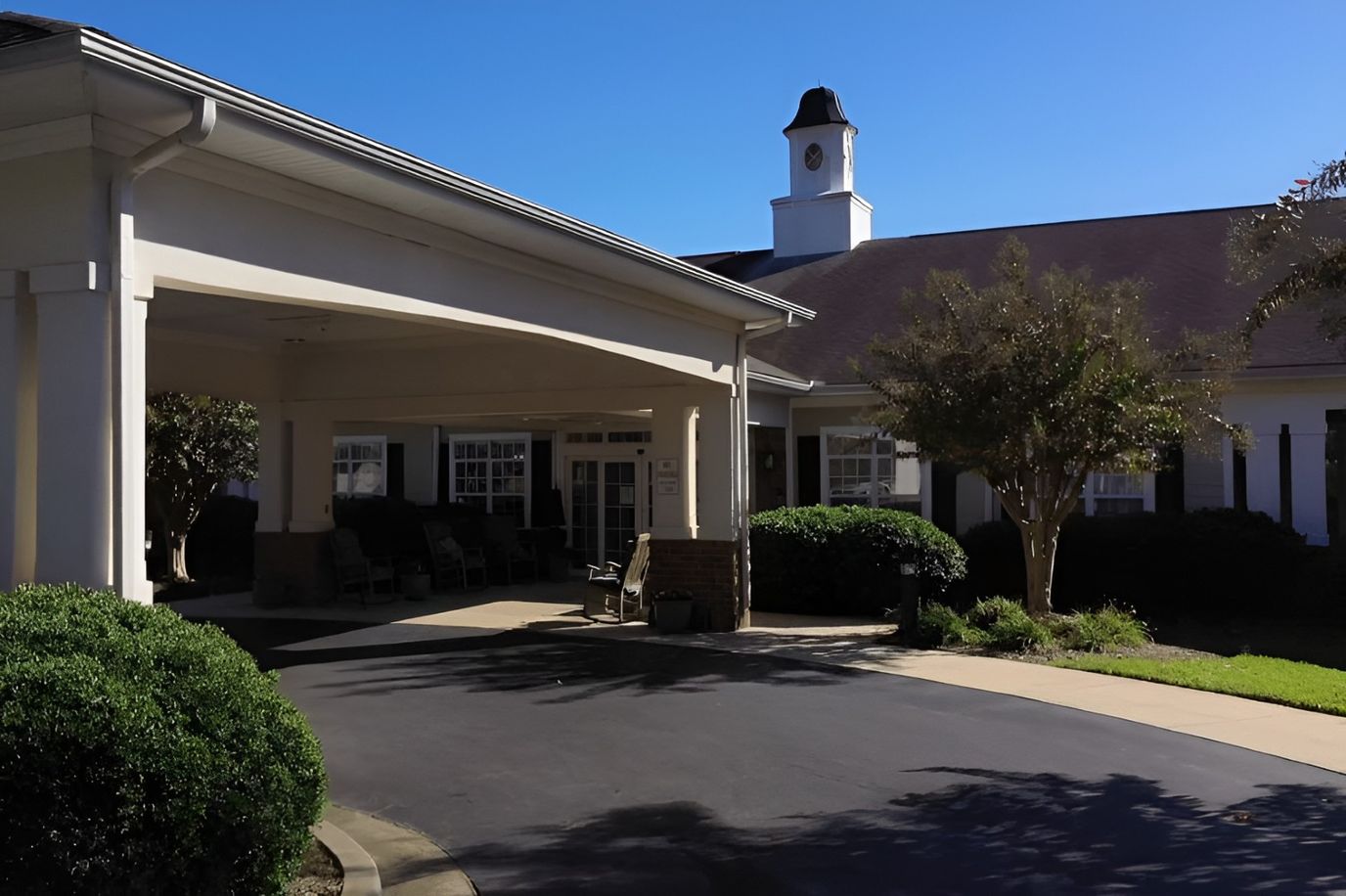 Exterior view of the facility entrance with shaded seating