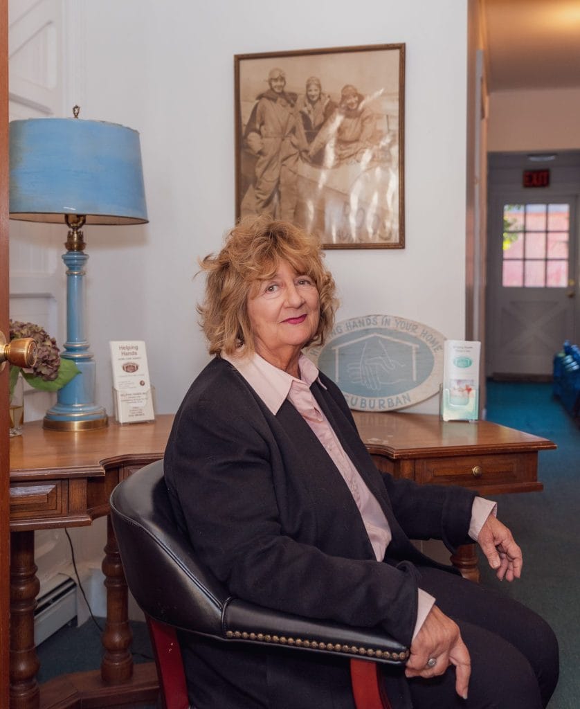 Staff member seated in a welcoming lobby area.