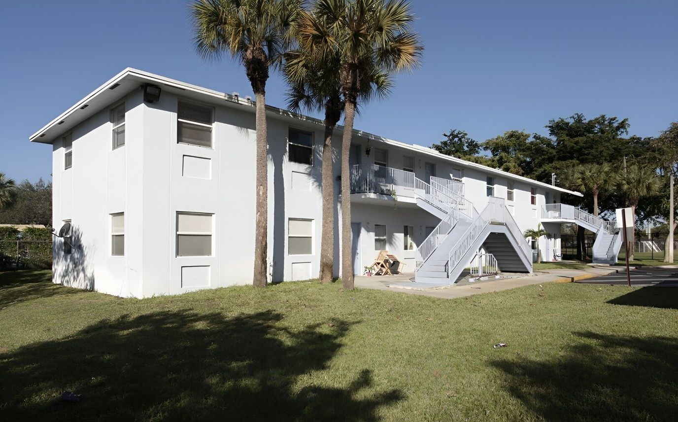 Exterior view of Apollo Terrace building surrounded by palm trees