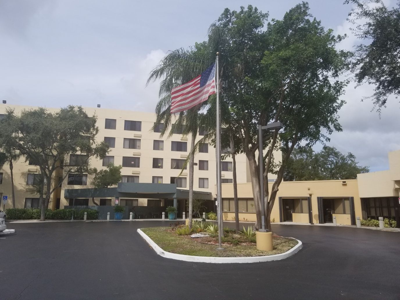 Exterior view of the facility with flag and landscaping