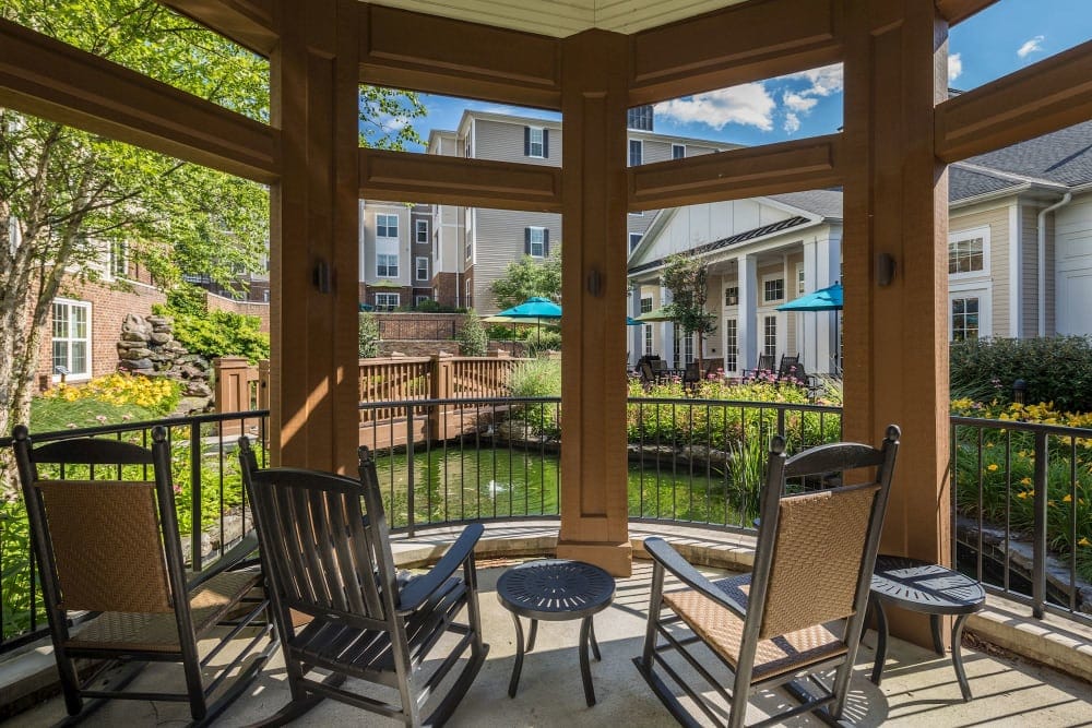 Seating area overlooking a serene pond and garden