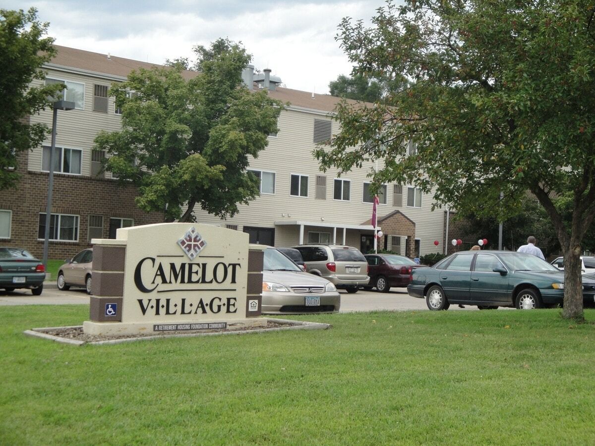 Exterior view of Camelot Village with the sign
