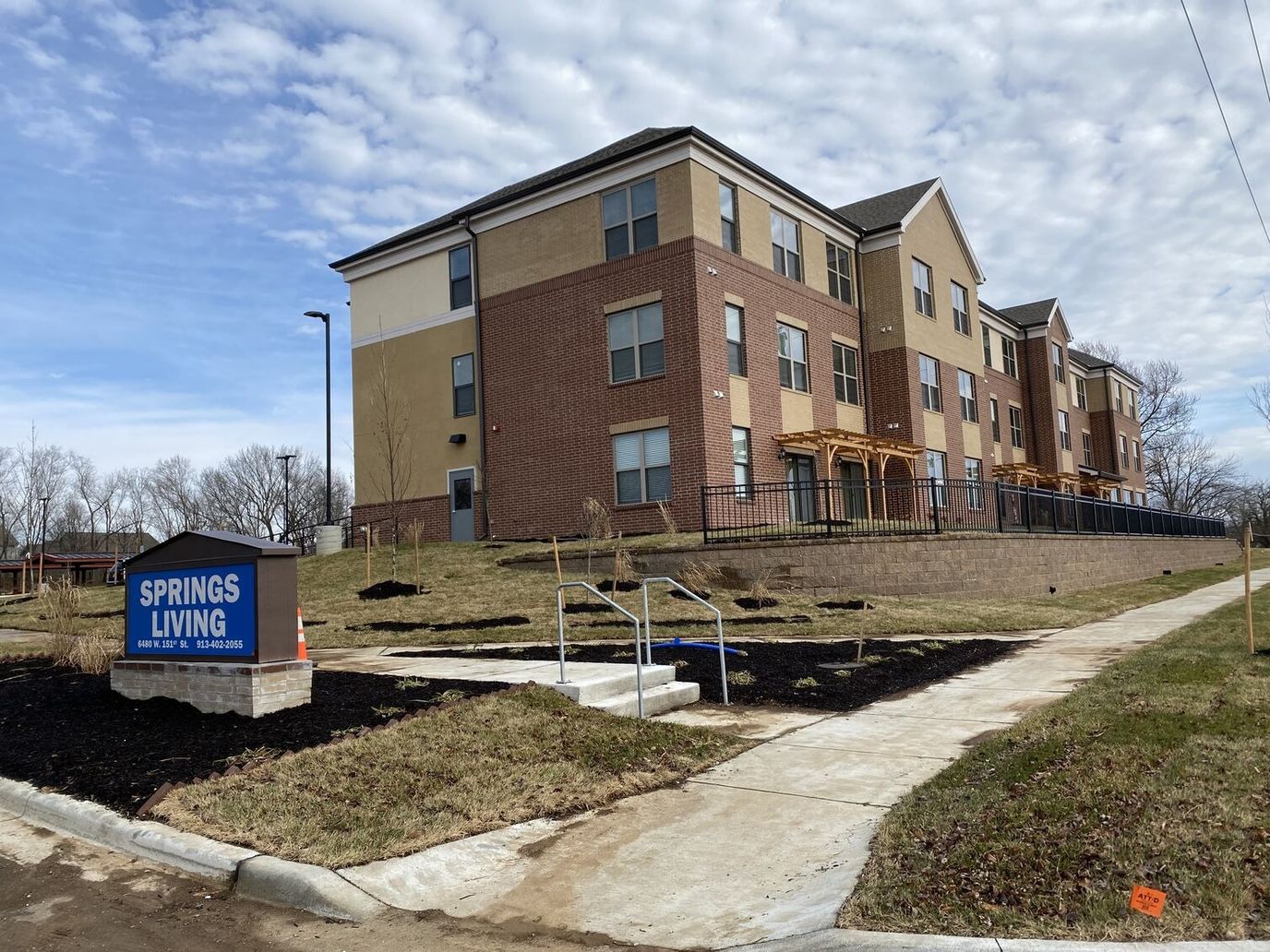 Exterior view of Springs Living facility with landscaping