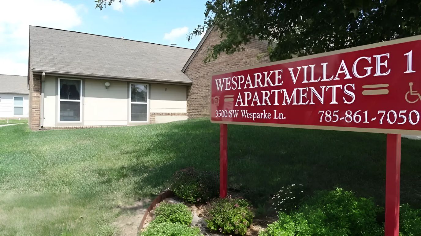 Exterior view of Wesparke Village Apartments with sign