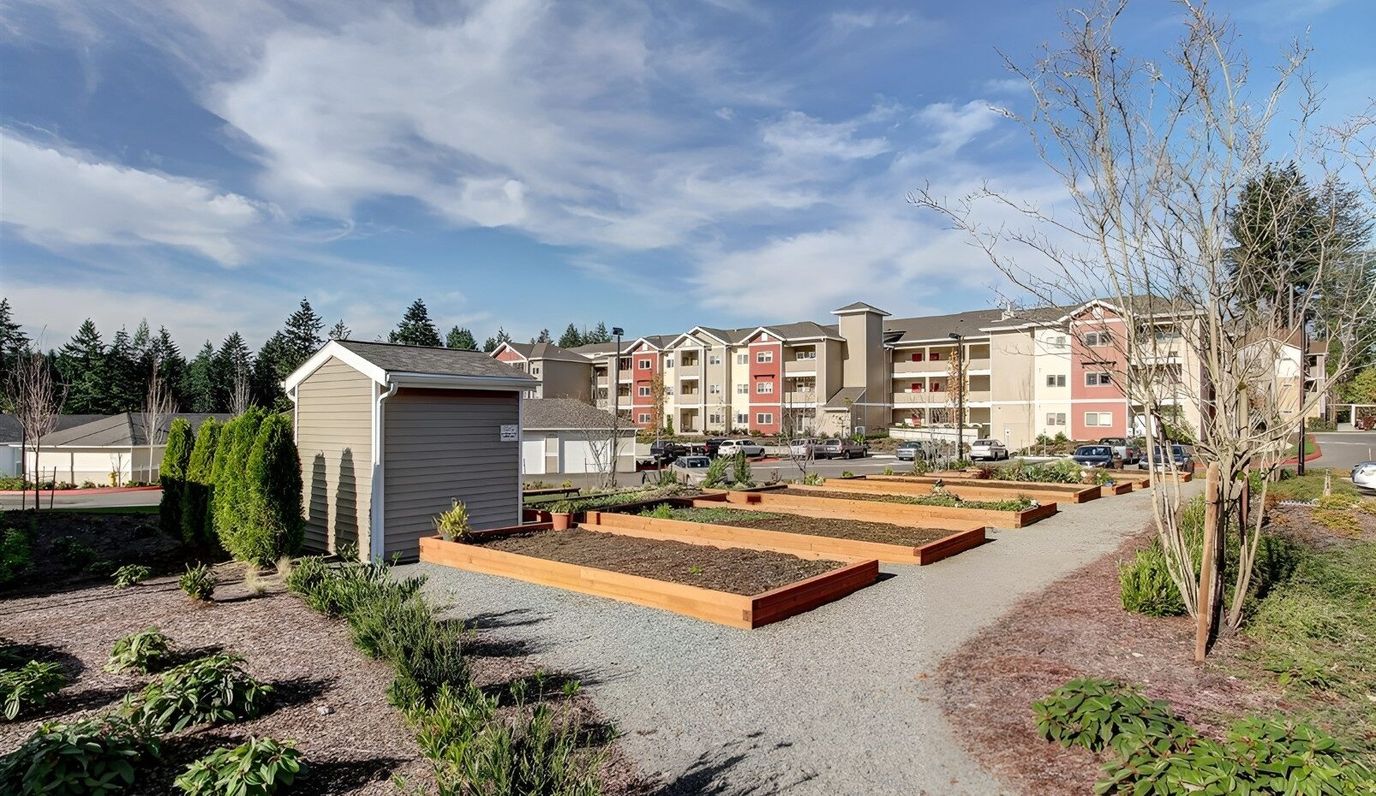 Outdoor view of the facility with garden beds and building