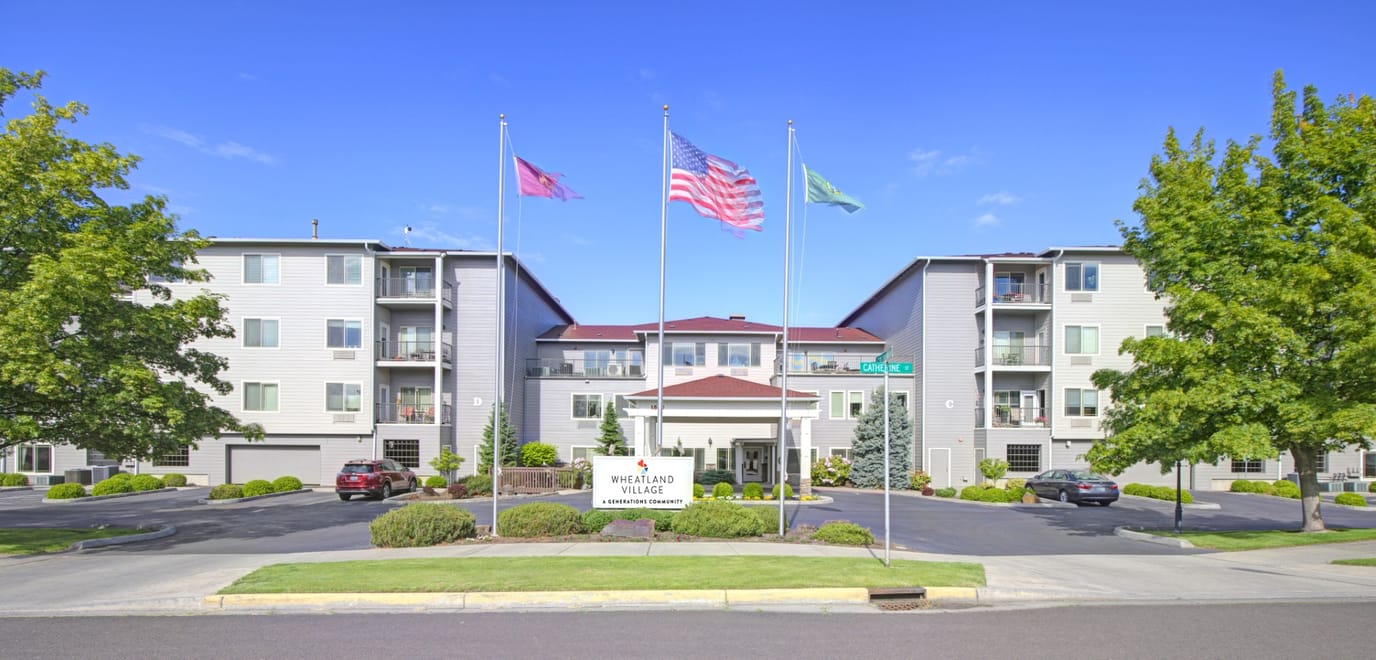 Exterior view of Wheatland Village facility with flags