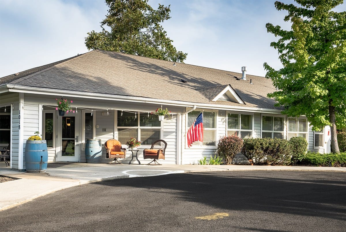 Exterior view of assisted living facility with flag