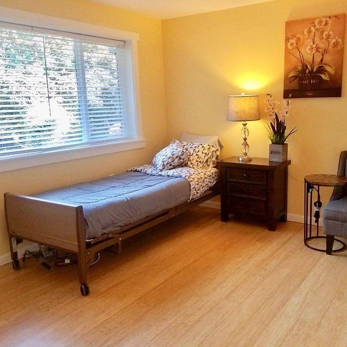 A cozy resident room with a bed and window