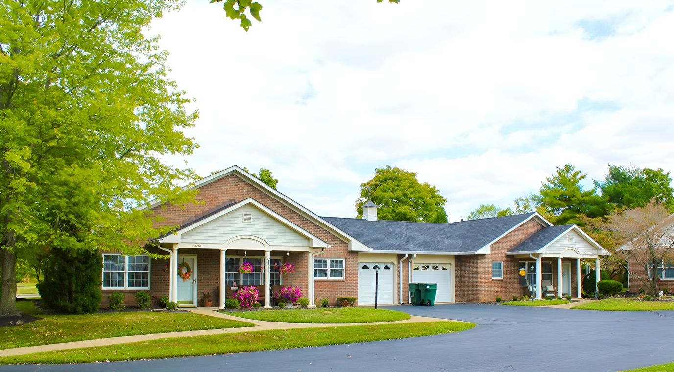 Exterior view of Garden Grace Apartments with landscaping.