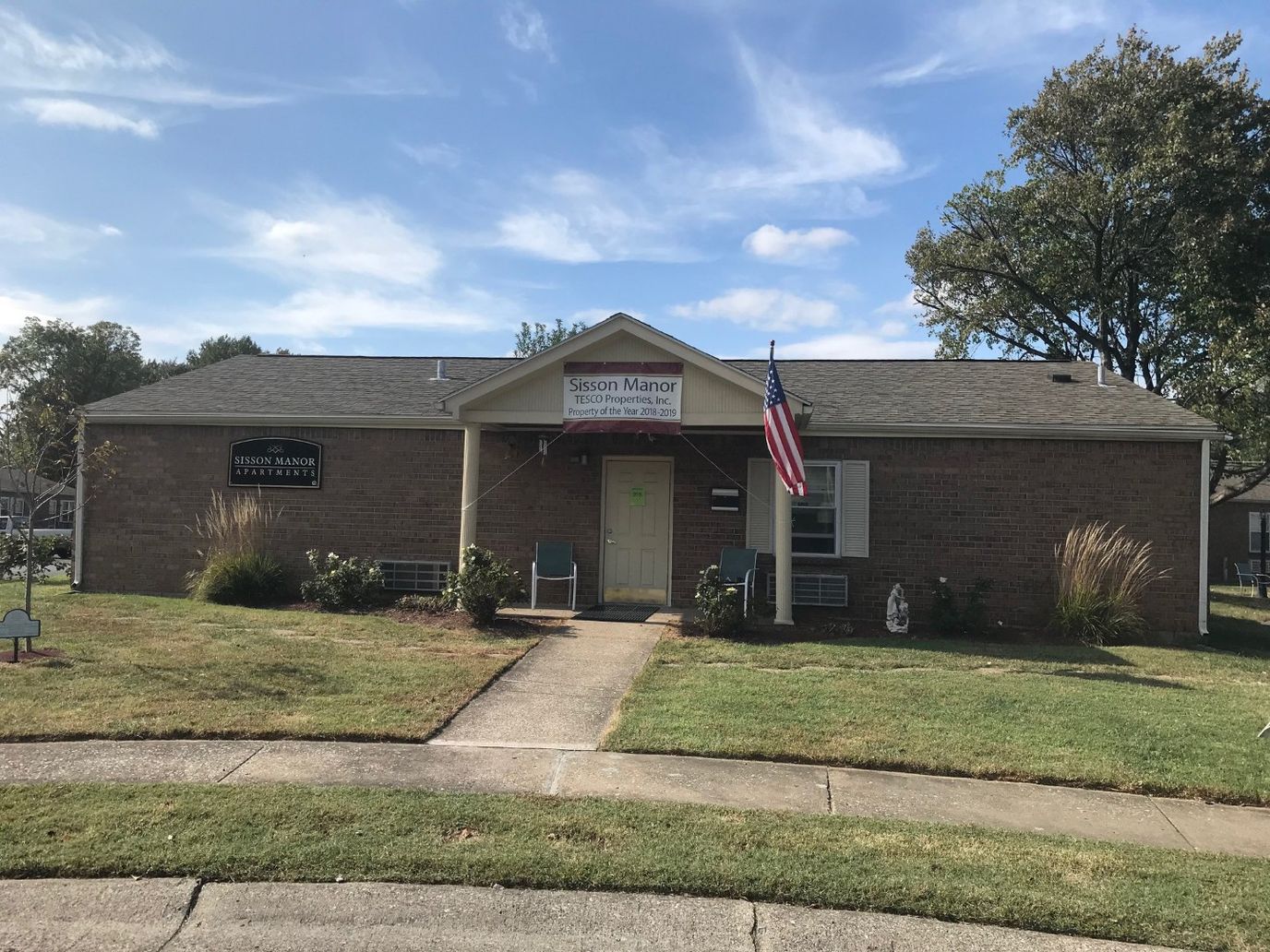 Exterior view of Sisson Manor building with lawn