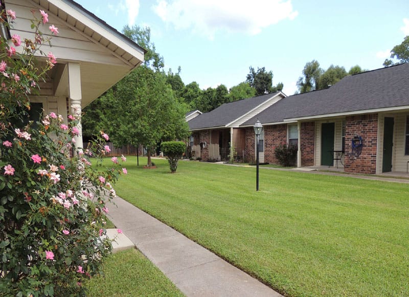 Well-maintained garden path with flowers and cottages at Heritage Village.