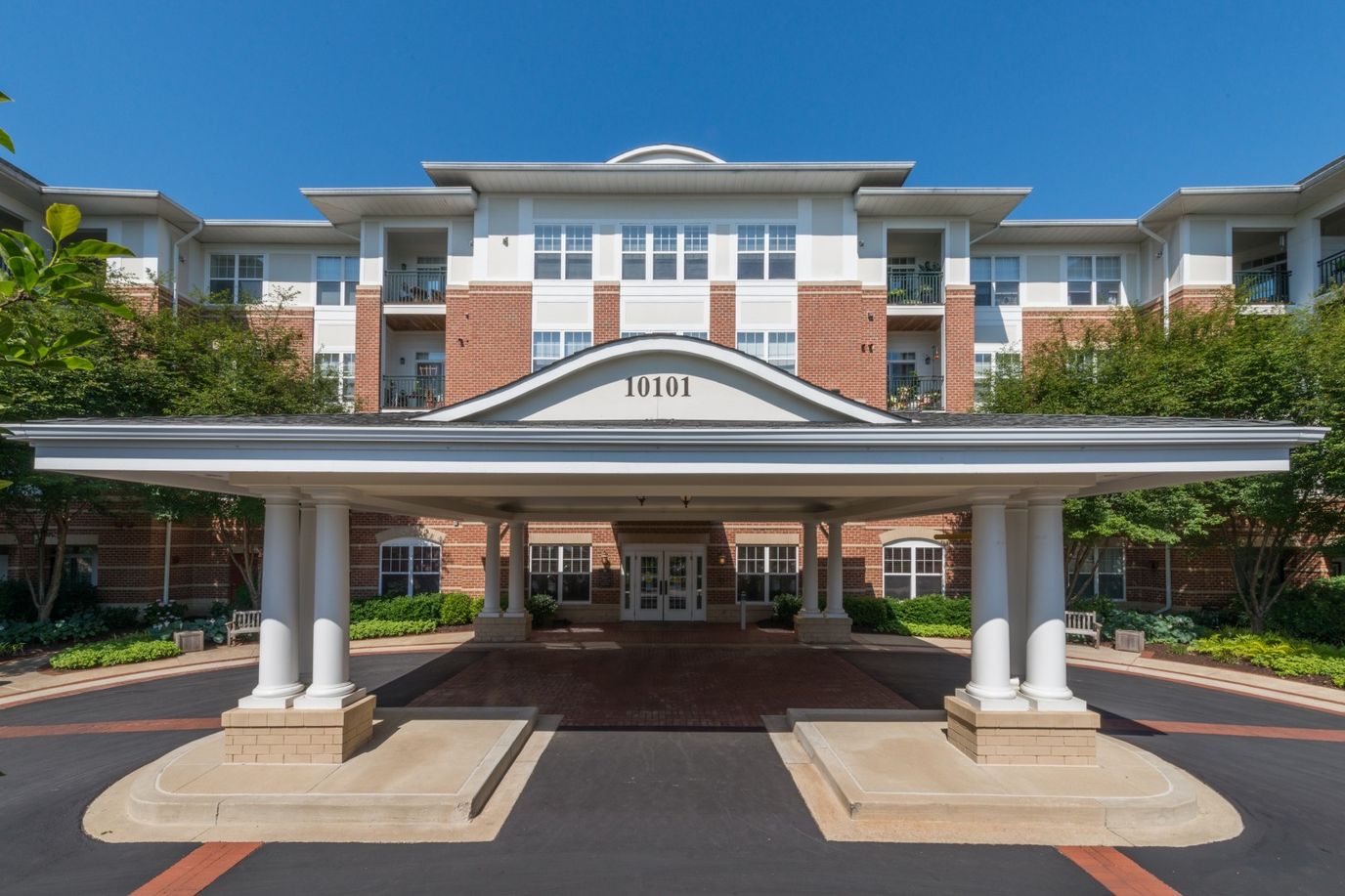 Front entrance of a senior living facility with covered drive