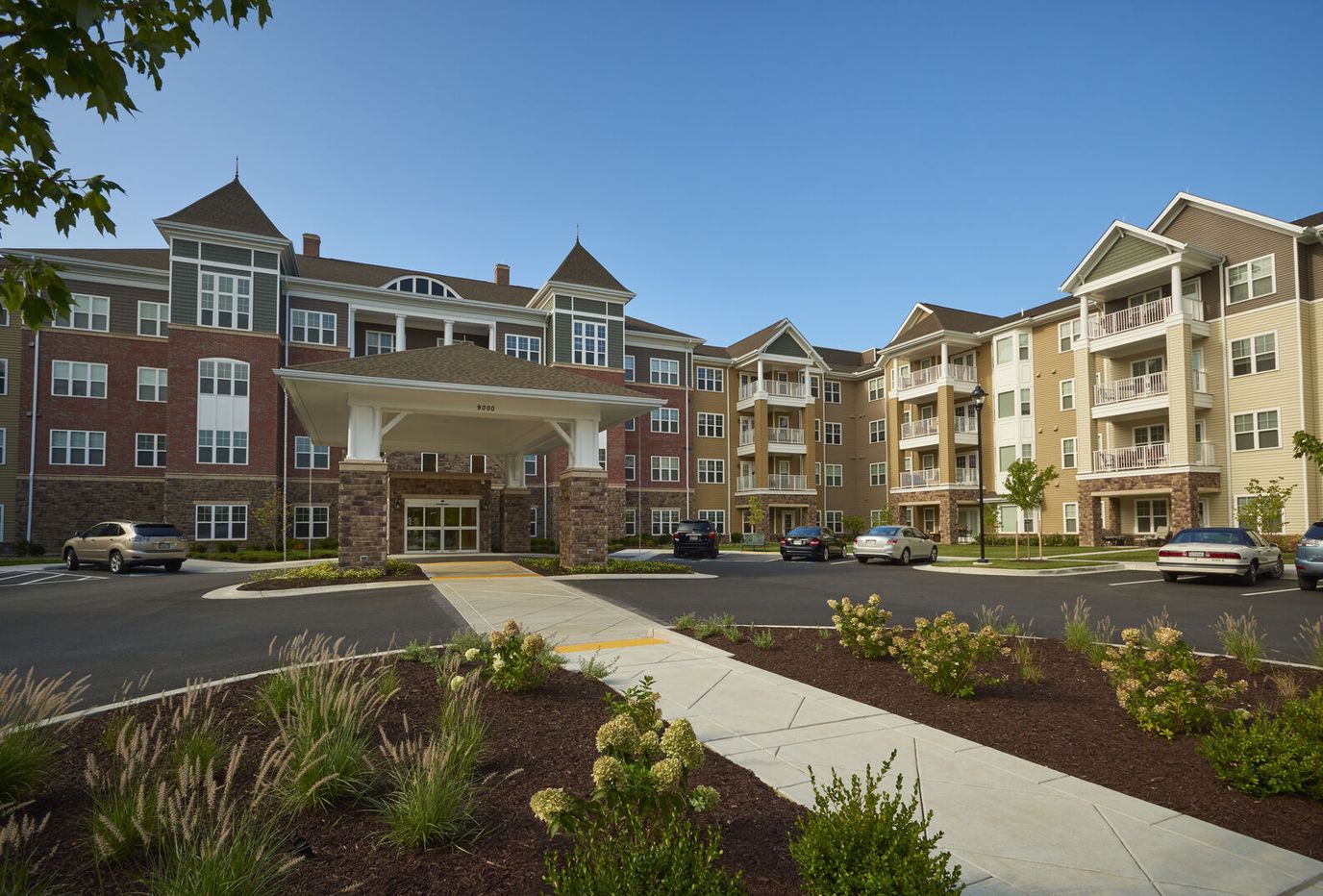 Exterior view of a senior living facility with garden