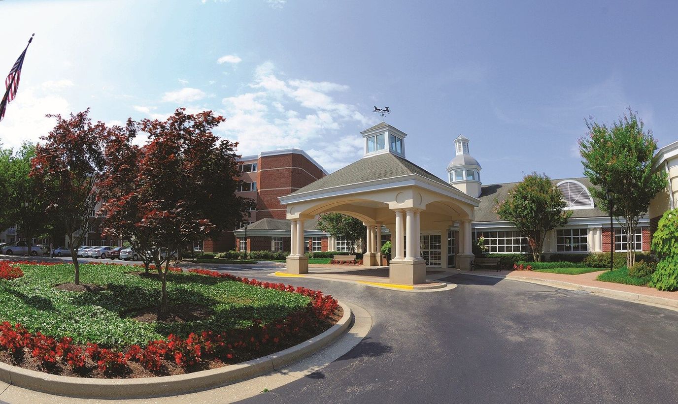 Front entrance of a senior living facility with landscaping