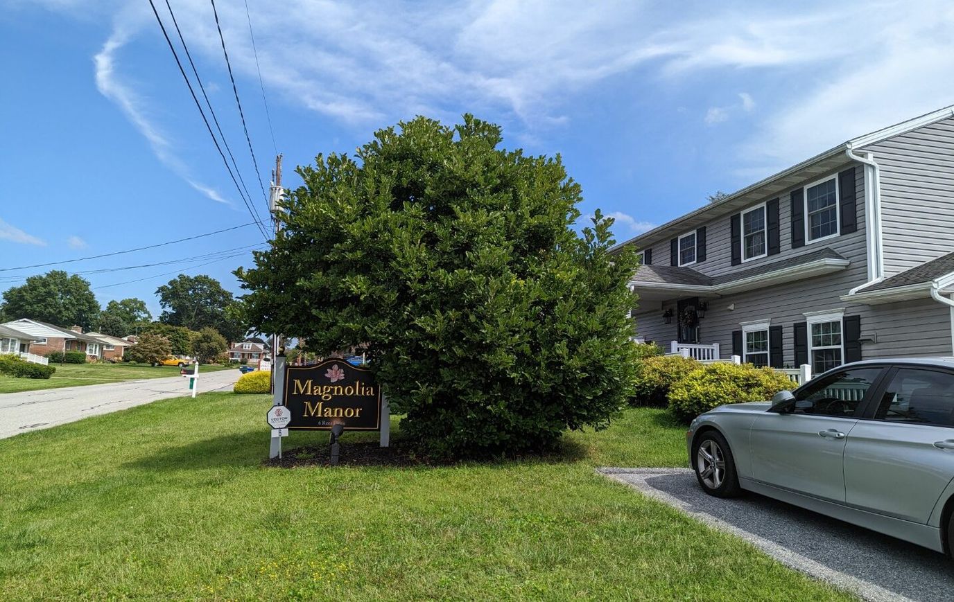 Exterior view of Magnolia Manor with signage