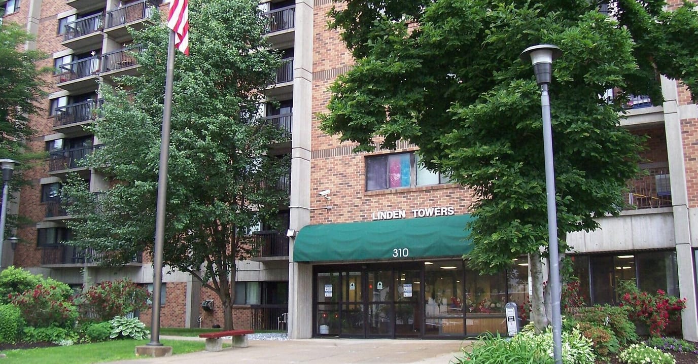 Exterior view of Linden Towers building with greenery