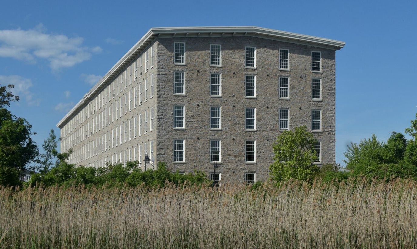 Exterior view of a historic building surrounded by greenery