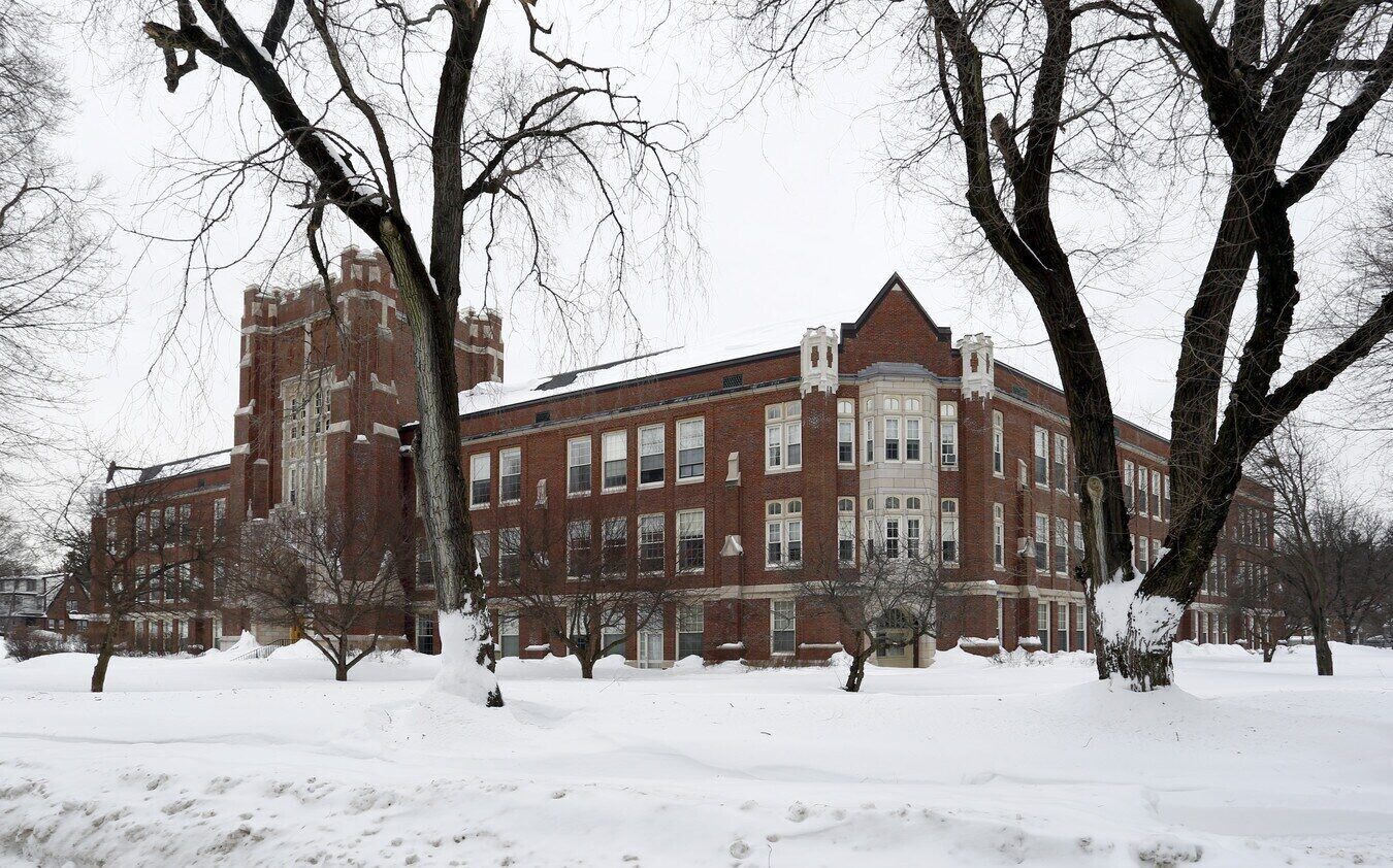 Exterior view of a large brick building in winter