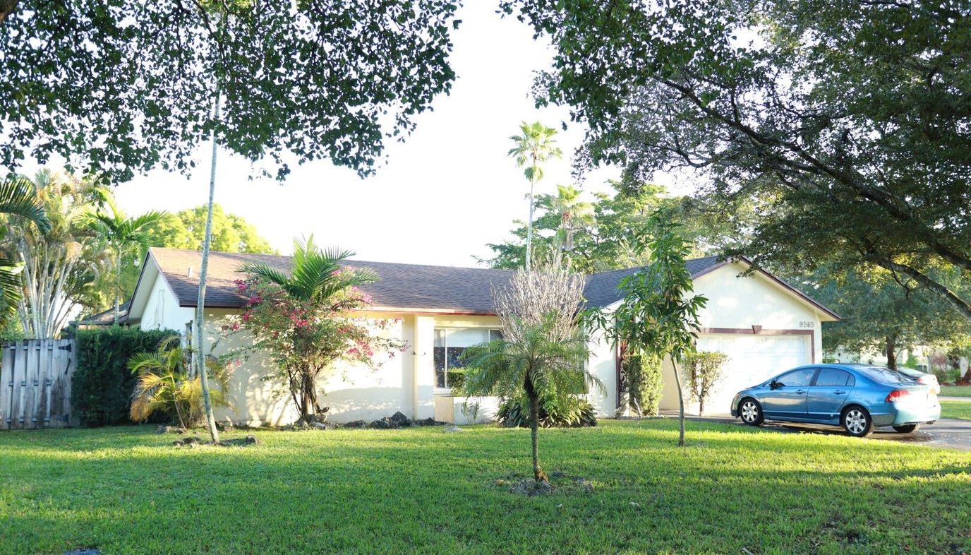 Exterior view of a senior living facility surrounded by greenery