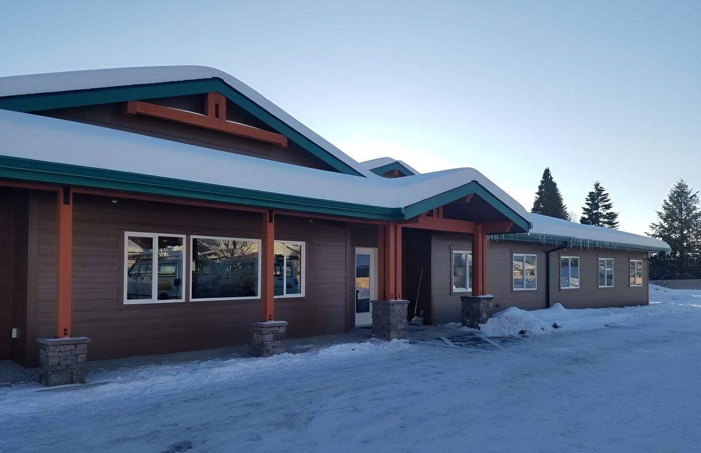 Exterior view of Harmony House Assisted Living building covered in snow