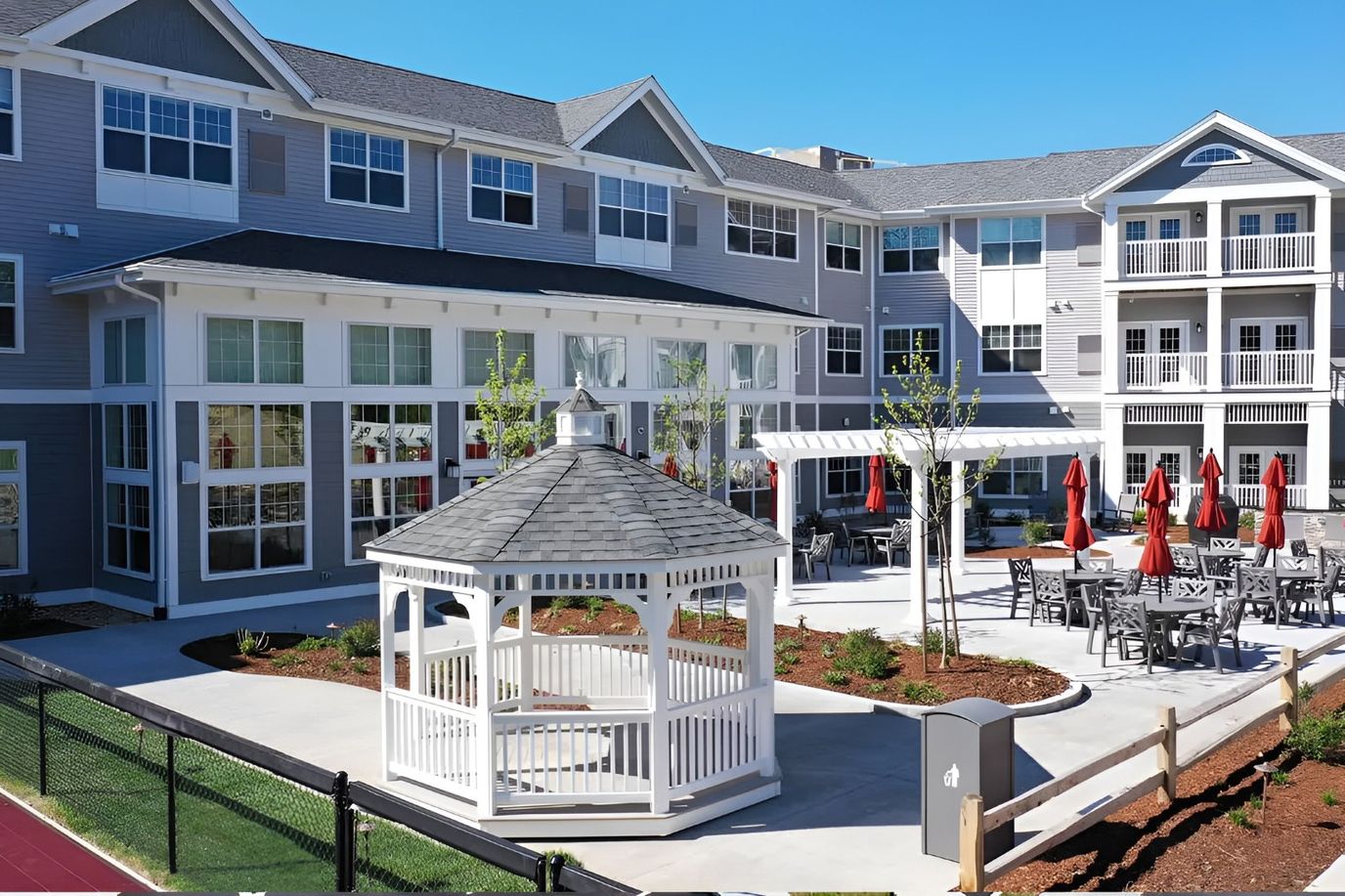 Exterior view of The Woods at Merrimack with outdoor seating and gazebo