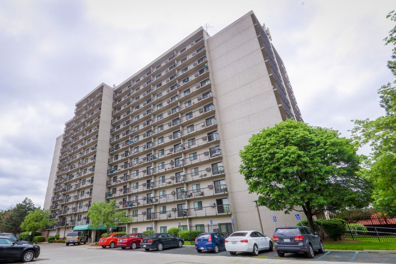 Exterior view of Cambridge Towers with parking lot