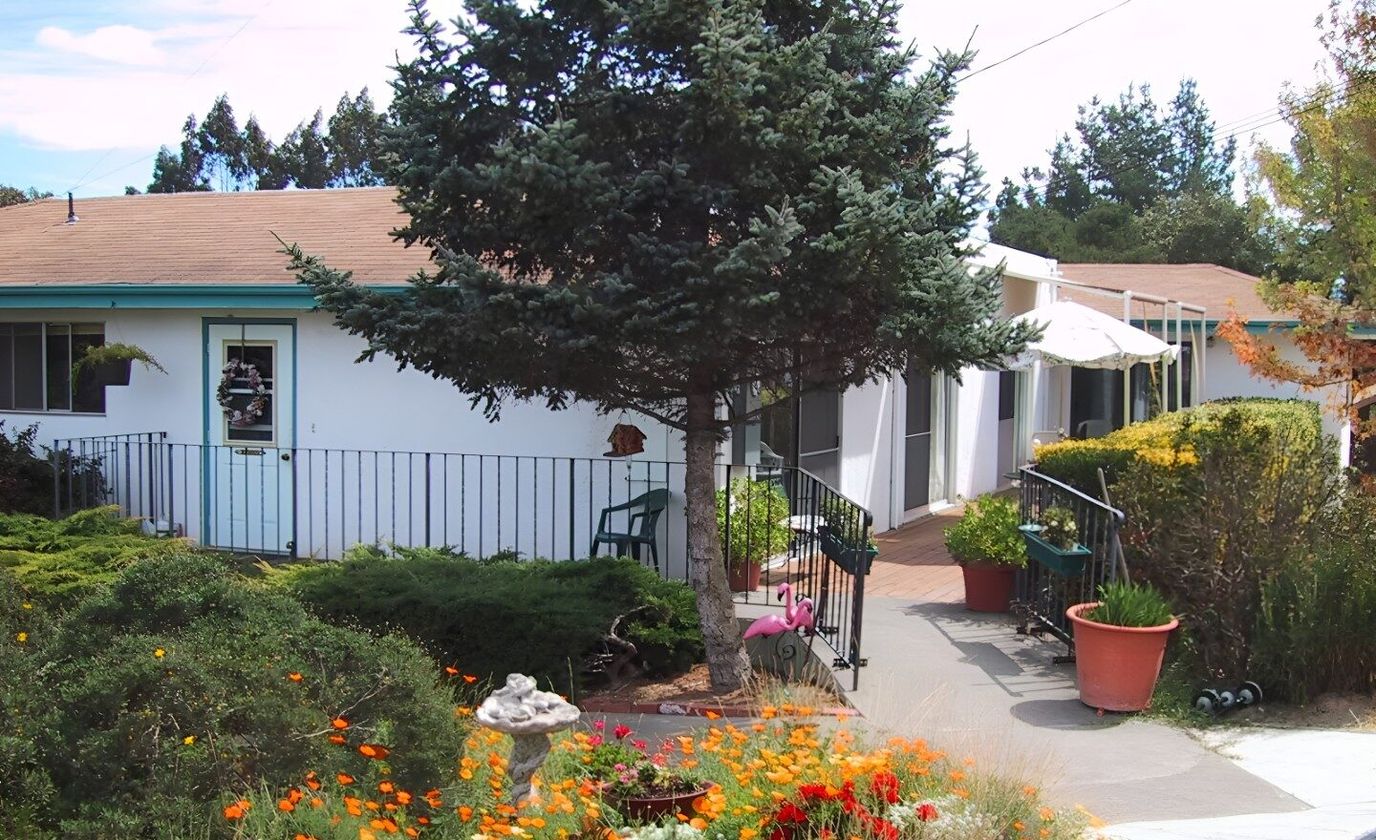 Exterior view of a residential care facility with gardens