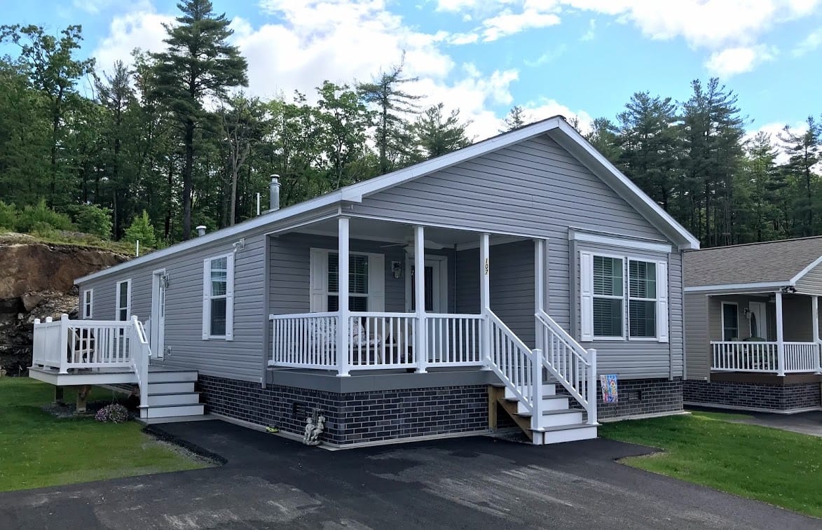 Exterior view of a gray residential building with a porch