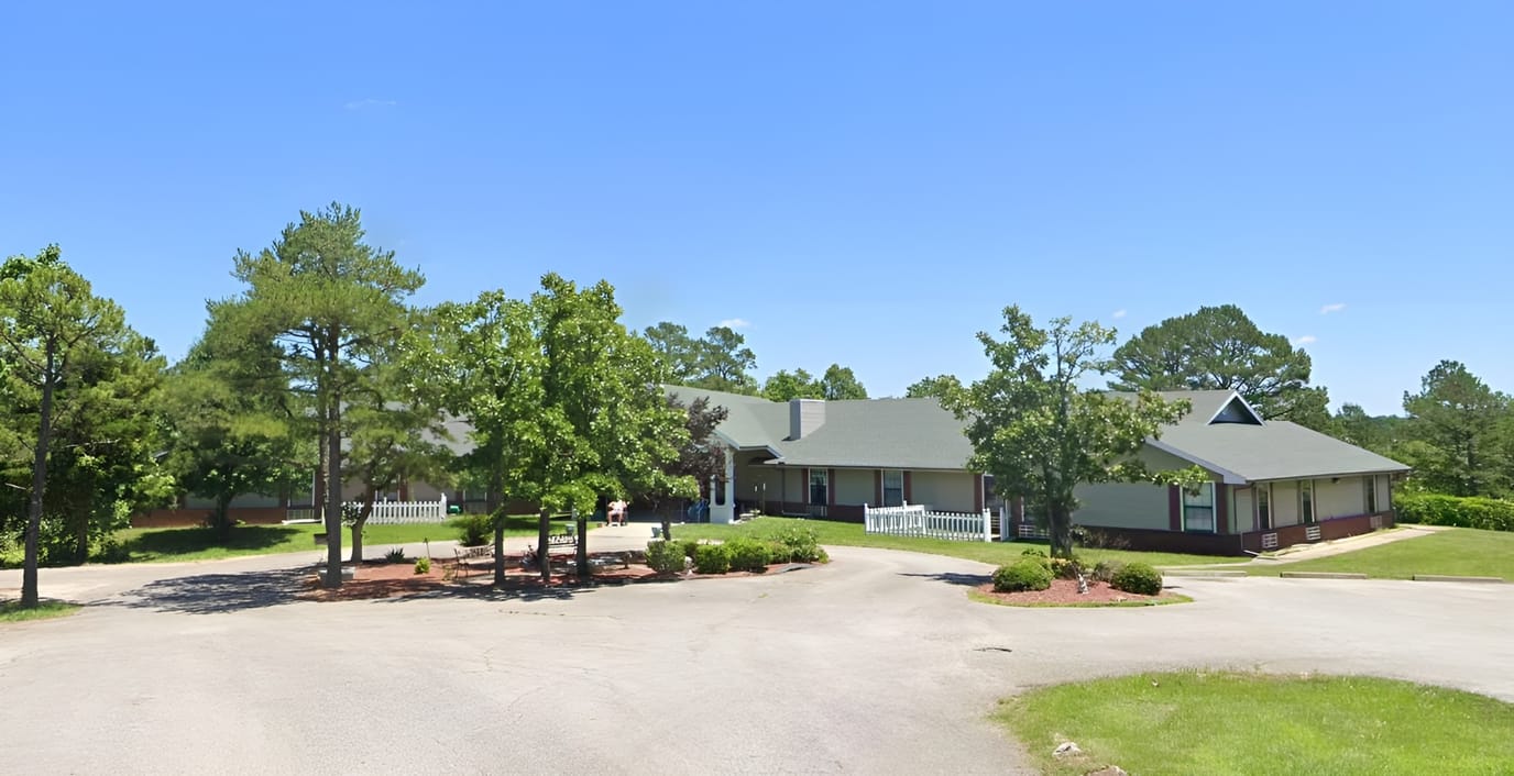 Exterior view of Holly House facility surrounded by trees