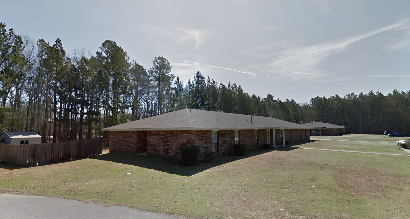 Exterior view of the facility surrounded by trees