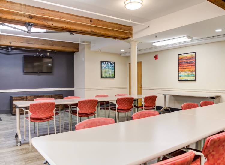 Empty activity room with tables and chairs