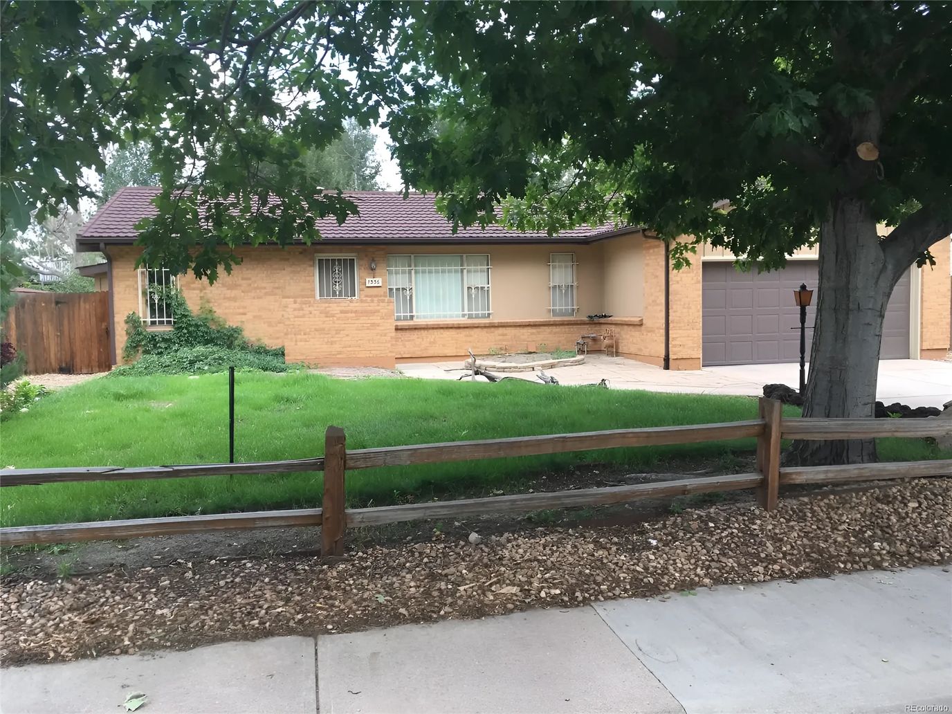 Exterior view of a senior living facility with yard
