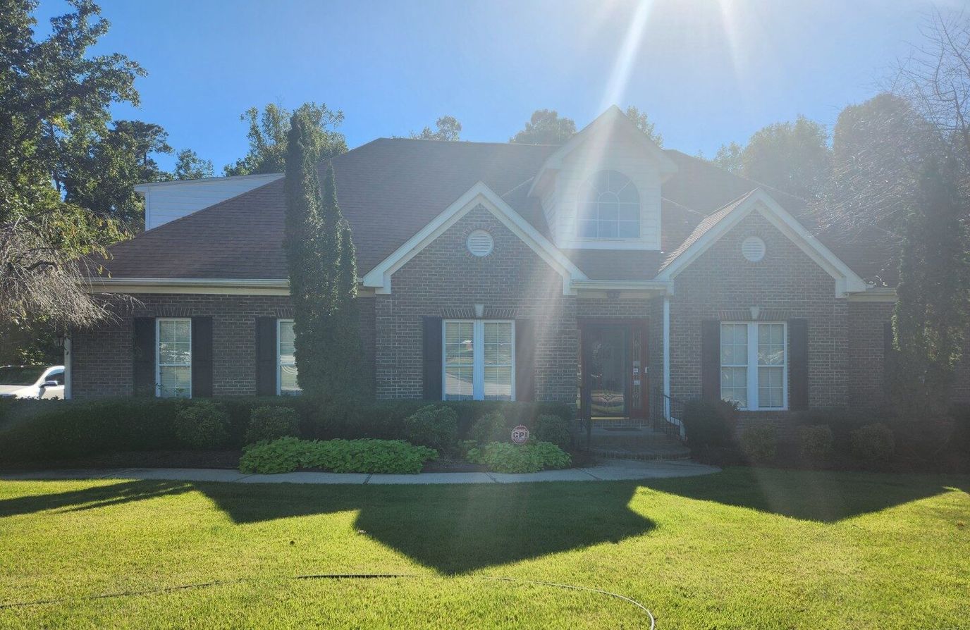 Front view of a residential building with a well-maintained lawn