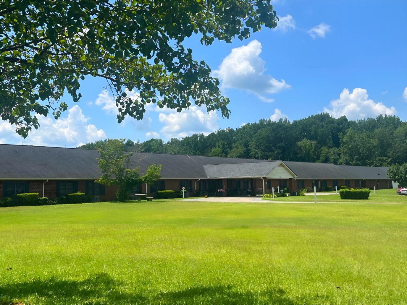 Exterior view of Parkview Retirement Center surrounded by greenery
