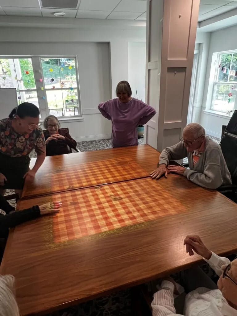 Residents enjoying a game at a large table