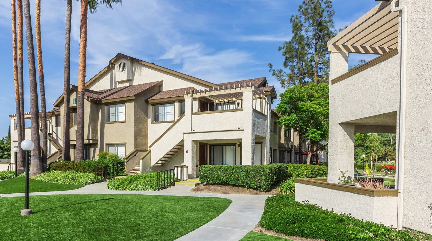 Exterior view of Sage Park Senior Apartment Homes with landscaped grounds